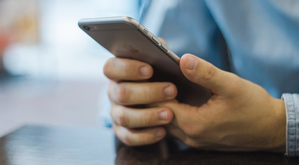 A teenager looking at their smartphone