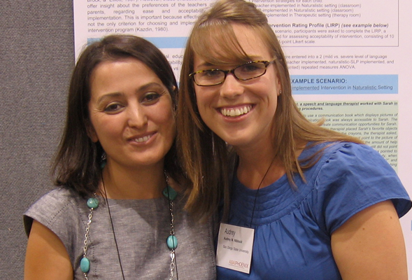 Yasemin Turan, left, and student Audrey Niblock at the SDSU Student Research Symposium with Niblock's poster presentation in background