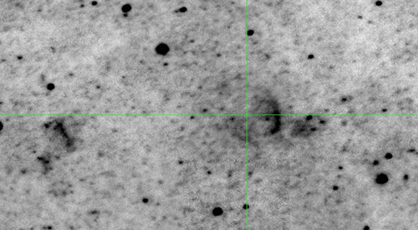 Crosshairs indicate the location of the nova studied. Remnant can be seen as a partial arc to the right of the nova.