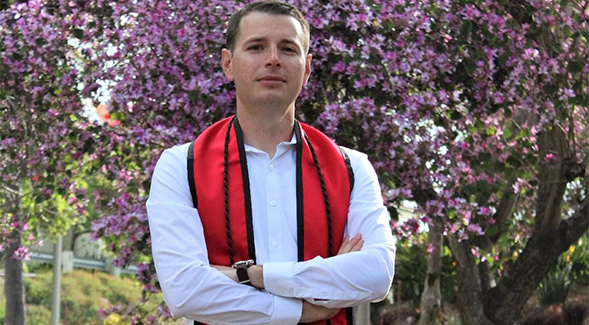 Eric Monette wear a veteran's cord for his graduation pictures.