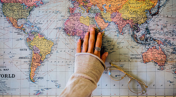 Hand pointing on world map
