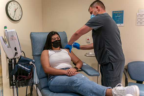 A student received a COVID-19 vaccine at Student Health Services in February. (Photo: Gary Payne)