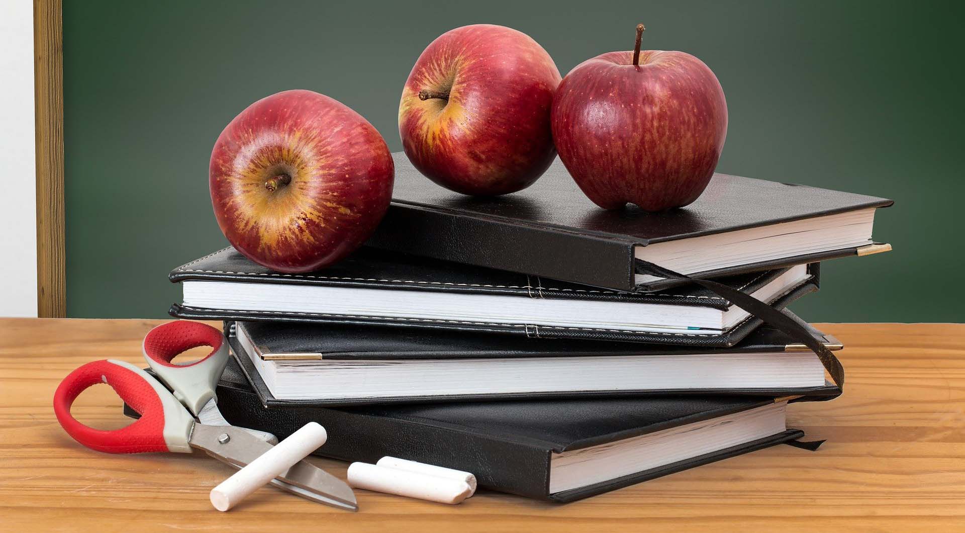 Apples and classroom supplies (Photo by Steve Buissinne / Pixabay.)