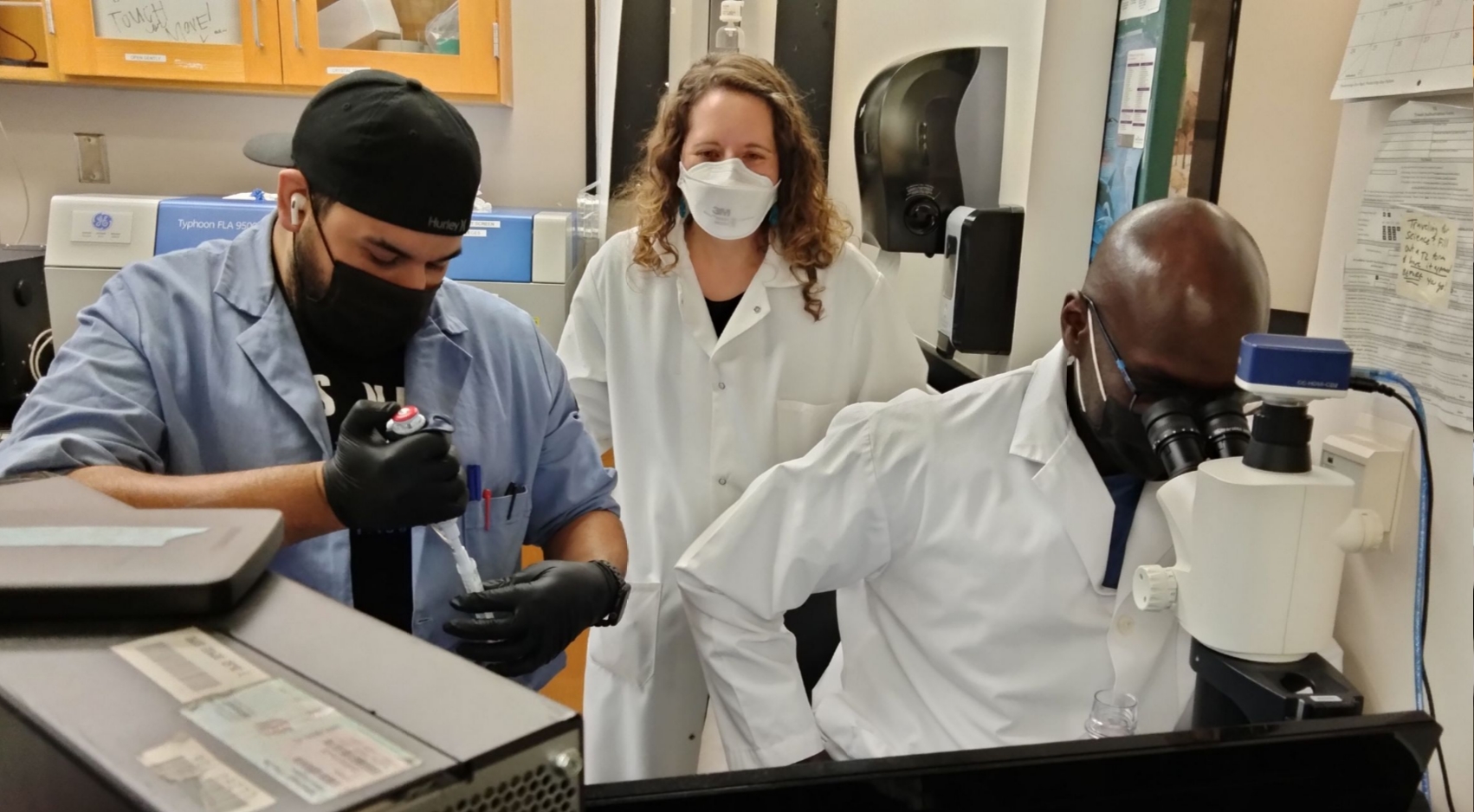 Graduate student Isaac Marquez, postdoctoral scholar Mowaffaq Adam and associate professor Christal Sohl in her lab at SDSU.