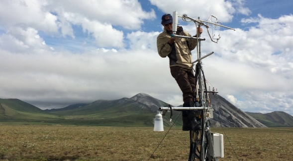 Kyle Arndt, Ph.D. '20 checks tundra monitoring instruments in Ivotuk, Alaska, 2016. Photo by Matt Pender.