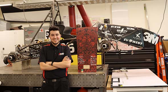 Juan Rojas posed in front of the Aztec Electric Racing Club's project, the AER-21. (Photo: Melinda Sevilla)