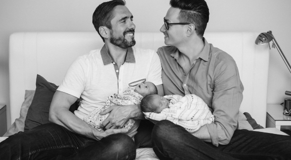 Steven Shyne (right), SDSU grad and CEO of Think Red Project, with husband, John, and their twins