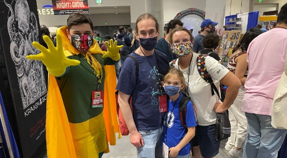 SDSU student and aspiring physician Fawaz Qashat (left) poses in costume with a family during Comic-Con San Diego. (Photo courtesy of Fawaz Qashat)