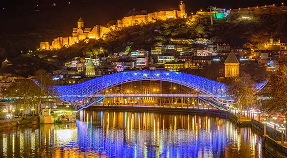The Bridge of Peace in Tbilisi, Georgia, illuminated at night. (Adobe Stock photo by Boris Stroujko)