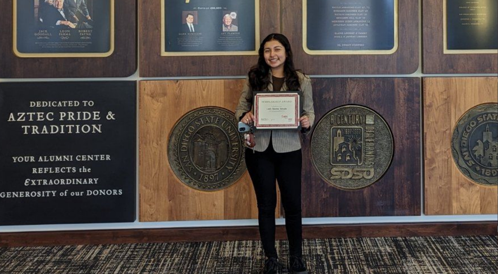 Lizeth Sanchez Zamudio accepts her MESA scholarship at the Parma Payne Goodall Alumni Center. (Courtesy photo)