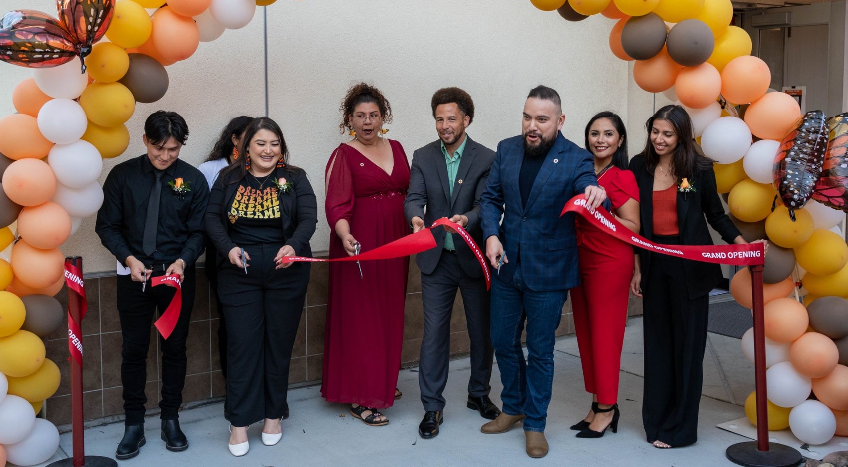 URC Director Cynthia Torres and SDSU VP of Student Affairs and Campus Diversity Luke Wood (center) are joined by supporters for the grand opening celebration of the university's new resource center.