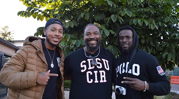 SDSU psychologist Ricky Pope (center) is joined by Derrick Premo Riddick Jr. (left), a rapper and author, and Joshua Hooper, a personal trainer, are photographed during a Barbershop Talks event.
