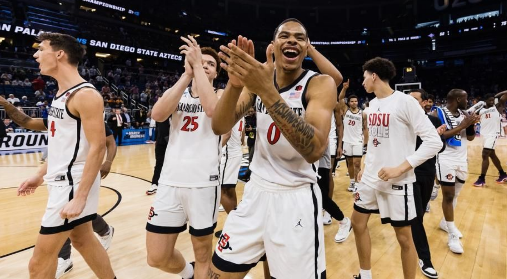 SDSU Forward Keshad Johnson (0) and Elijah Saunders (25) celebrate Aztecs' 75-52 win over Furman on Saturday in the second round of the NCAA Tournament. (SDSU)