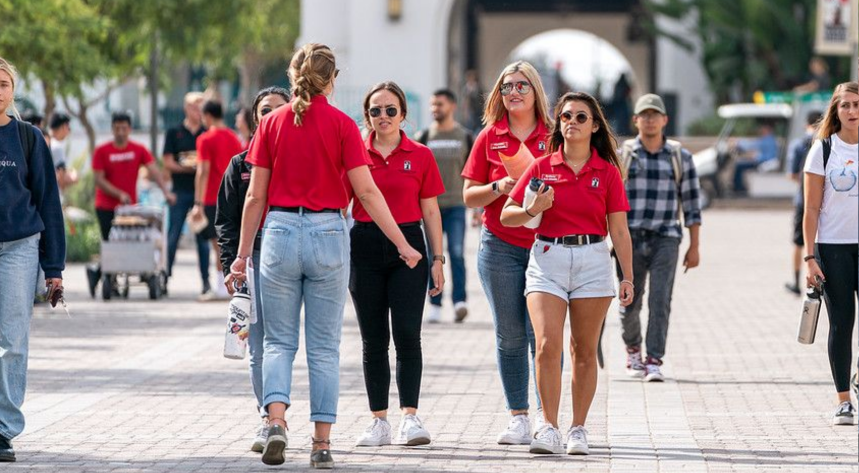 SDSU Ambassadors are photographed walking along Centennial Walkway. (SDSU)