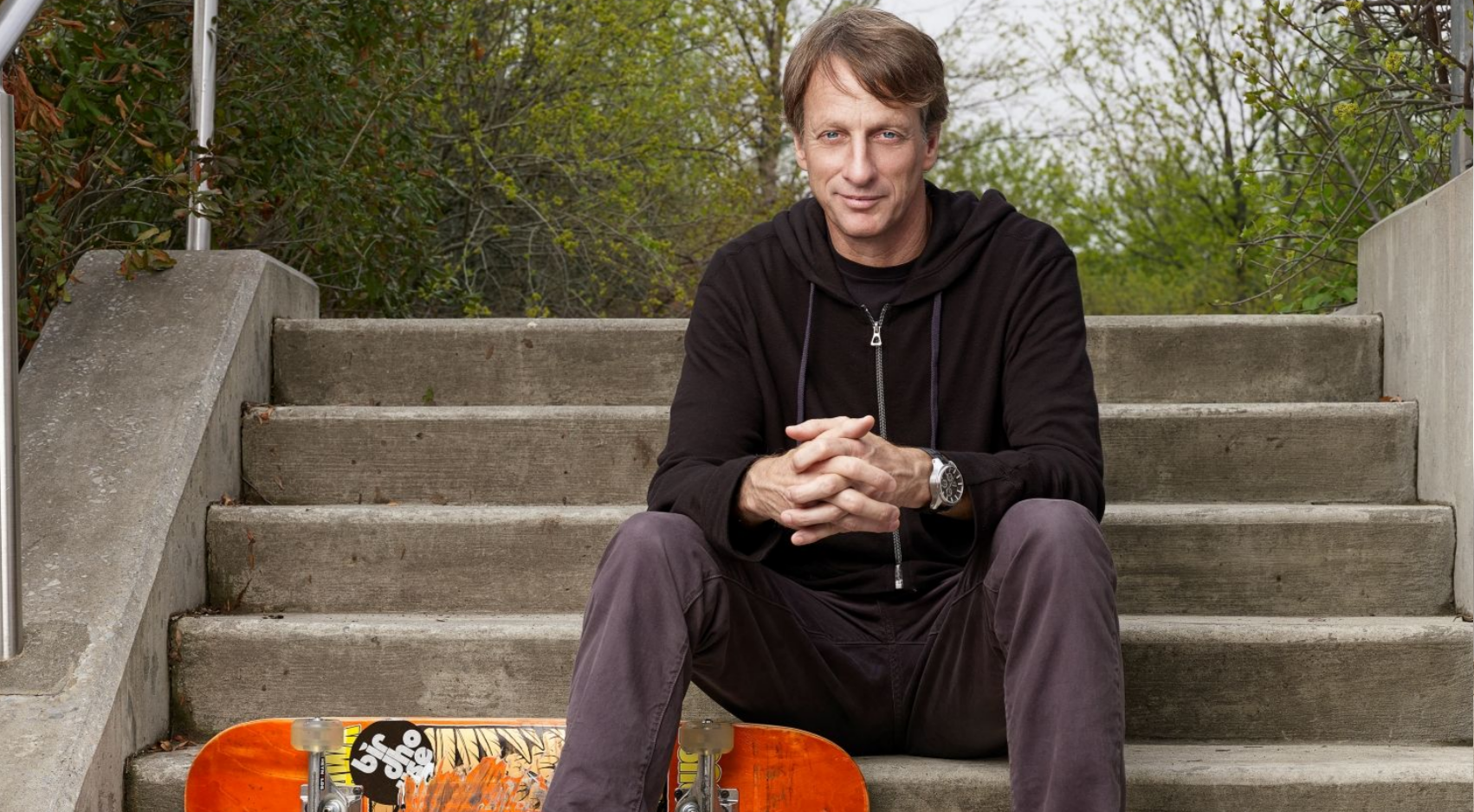 Tony Hawk, above, posed with a skateboard on a staircase. (Photo: Joshua Cutillo)