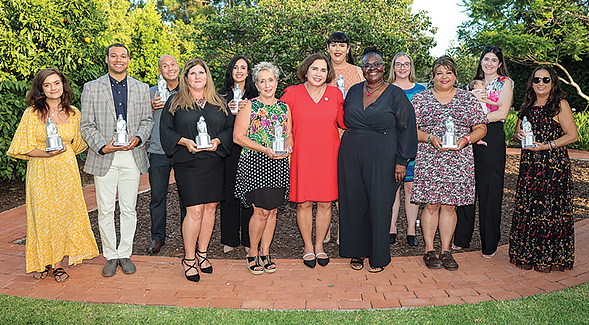 The 2023 SDSU Presidential Staff Excellence Award recipients were honored at University House by President Adela de la Torre (identifications at bottom of article). (Photo: Scott Hargrove)