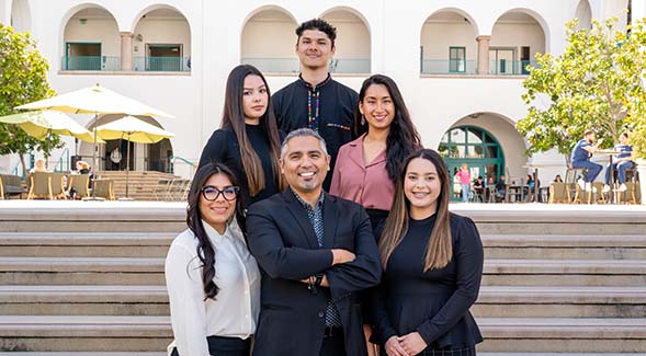 The staff of the SDSU HSI and Regional Affairs office gathered at the steps to the Lee &amp; Frank Goldberg Courtyard. (See footnote to article for identifications)