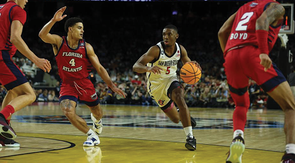 SDSU's Lamont Butler (5) drives between FAU defenders during 2023 Final Four game. (SDSU)