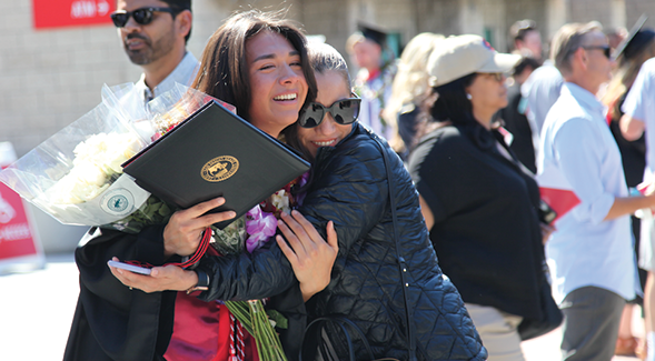 SDSU graduate is reunited with her mother following 2022 commencement. SDSU is No. 15 in U.S. for bachelors degrees awarded to Hispanic/Latinx students in 2021-22. (Mario Sevilla/SDSU)