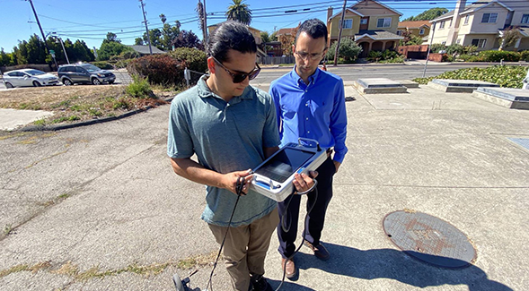 Hassan Davani (right) and Kian Bagheri, a graduate student in Davanis lab, collect shallow groundwater table data around vulnerable sewer infrastructure. (Photo courtesy of Ezra Romero/KQED)