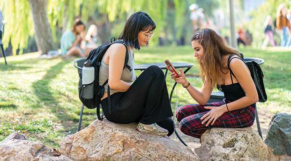 SDSU students socialize at the rocks surrounding the Turtle Pond on campus. (SDSU)