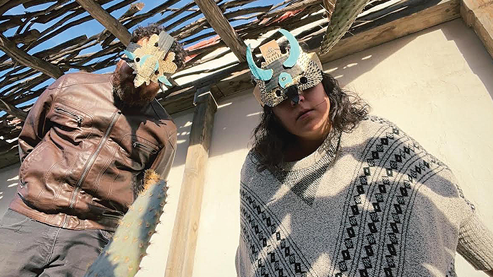Artist Collective Xingaderas wearing papier-mâché masks similar to those that will be constructed in their SDSU workshop.
