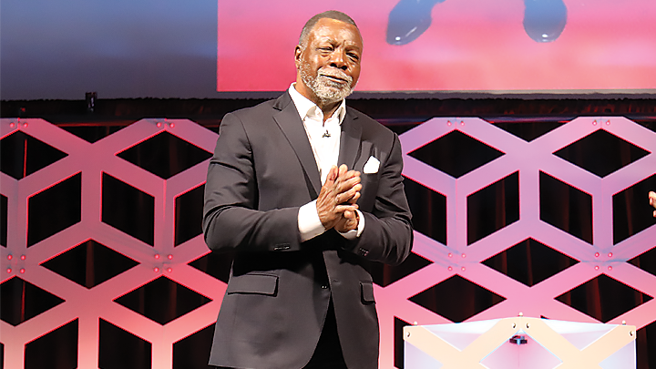 SDSU alumnus Carl Weathers clasps his hands and smiles during SDSU President’s Lecture Series.