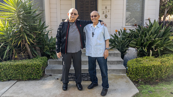 Brothers Lloyd Dong Jr. (left) and his brother Ron stand outside of their childhood home on C Street in Coronado. (SDSU)