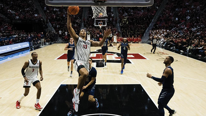 Aztecs forward Jaedon LeDee (13) soars to the hoop during SDSU's win over Nevada, 71-59, Jan. 17, 2024, at Viejas Arena. (Derrick Tuskan/SDSU)