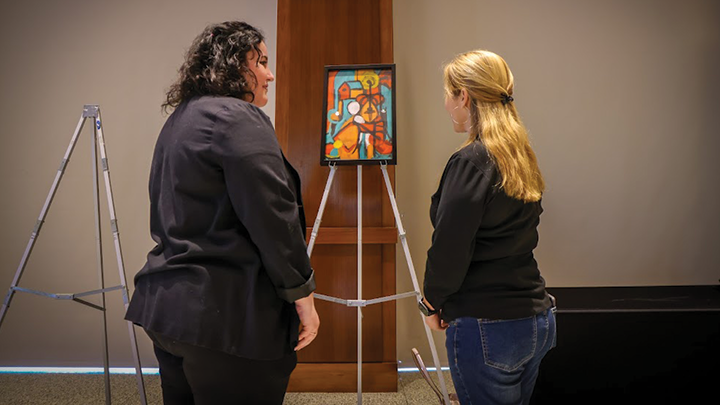 Anisa Prom and her mother view her painting