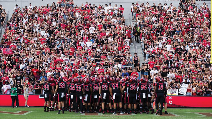 SDSU Aztecs Football team takes the field at Snapdragon Stadium in front of the student section.