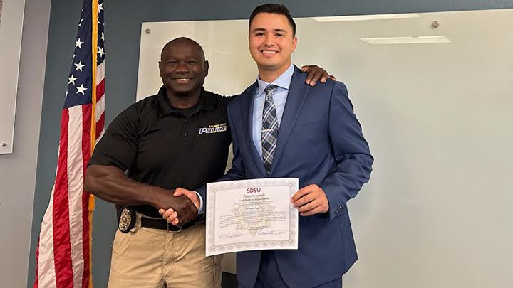 SDSU Police Department Chief Gregory L. Murphy poses for a photo with Daniel Tapia. 