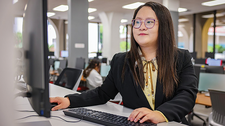 An SDSU researcher performs work on a computer.