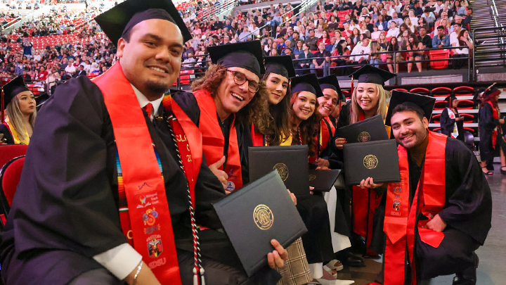 A file photo of SDSU students dressed in their caps and gowns.