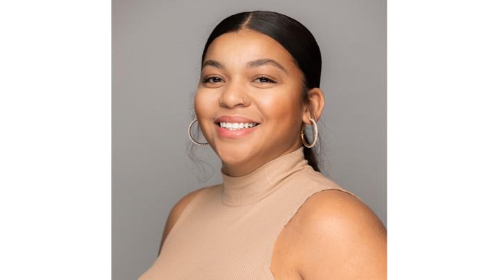 SDSU grad Vanessa Villarreal smiles in a portrait photograph