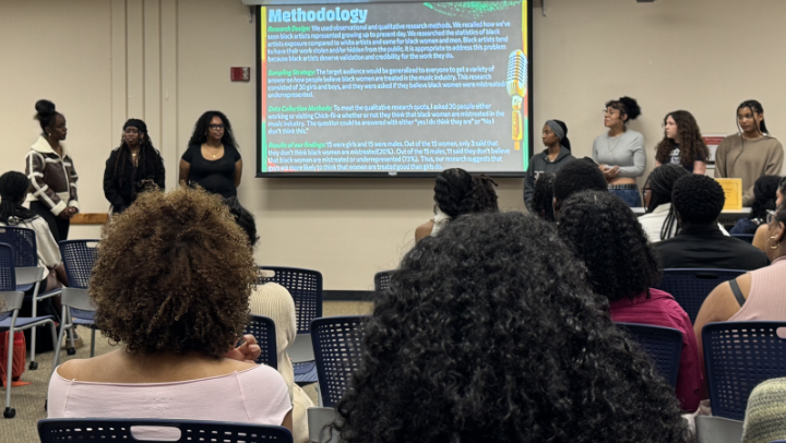 Students present to a room full of students during the fifth annual Black Research Symposium