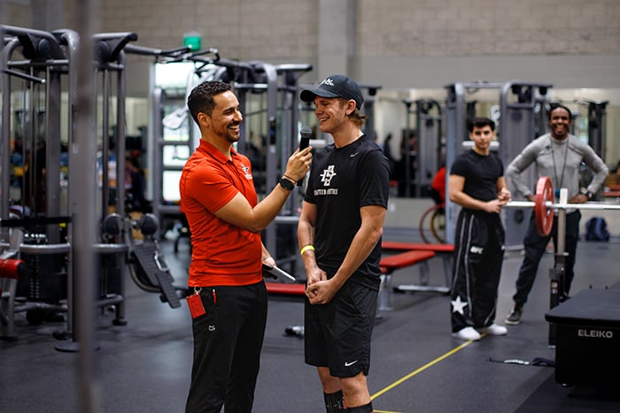 Munoz-Bond and an athlete at the program’s annual fall fundraiser, Lift-A-Thon, where students and Aztec Recreation members are invited to put their strength to the test in two lifting challenges. (SDSU)