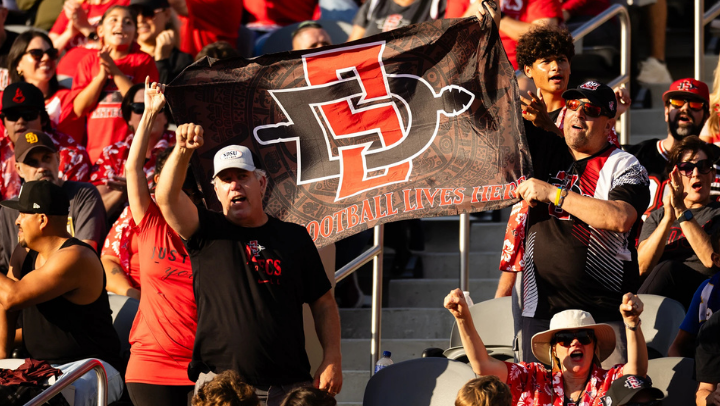 SDSU football fans celebrate in the stands at Snapdragon Stadium.