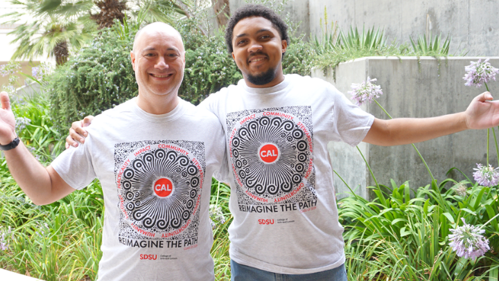 Joshua Scott and Joe Brumfield display the new first-year T-shirt design. Not pictured: Emma Powell. (Leslie L.J. Reilly/SDSU)