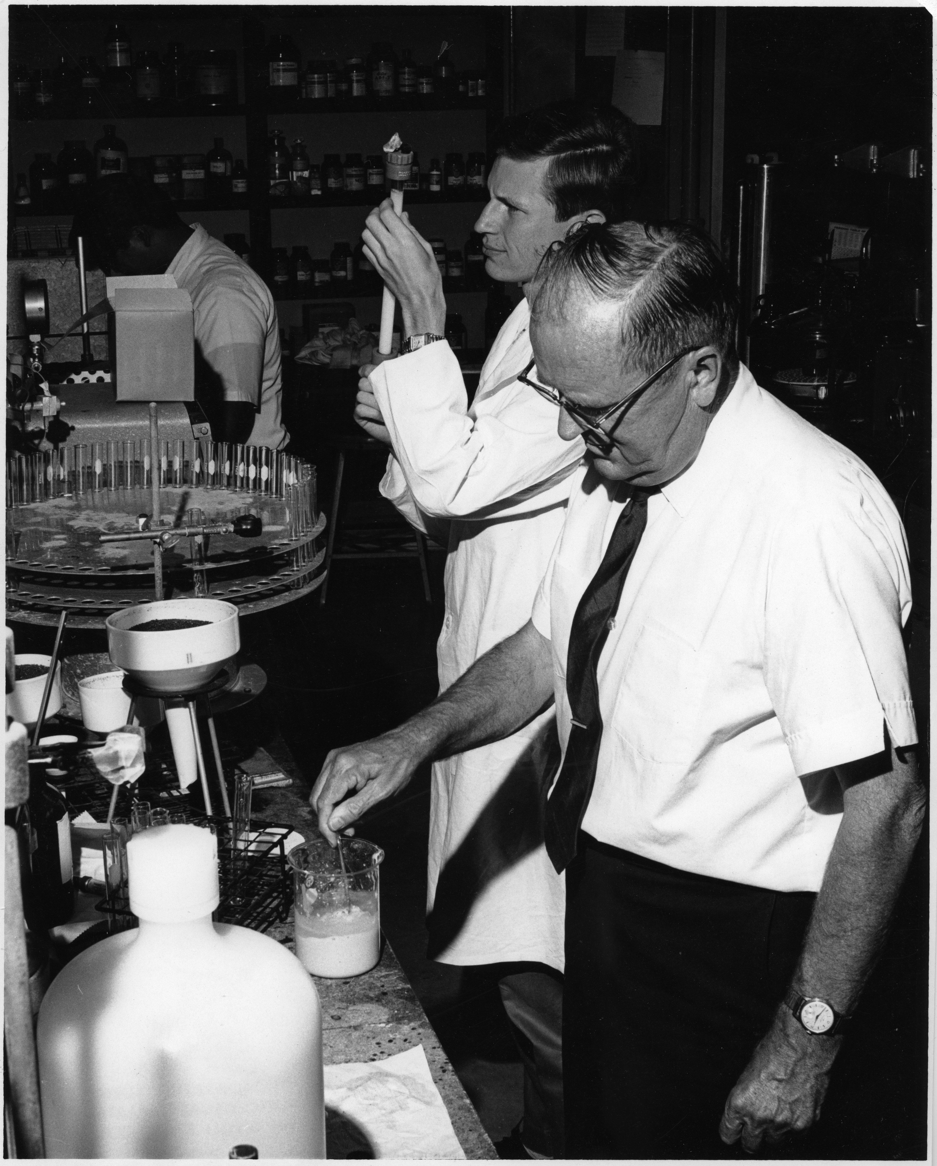Person wearing a white shirt and glasses in black and white
