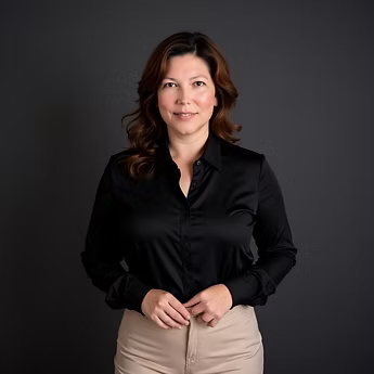 Photograph of a woman wearing a black, open-collar top and tan pants.