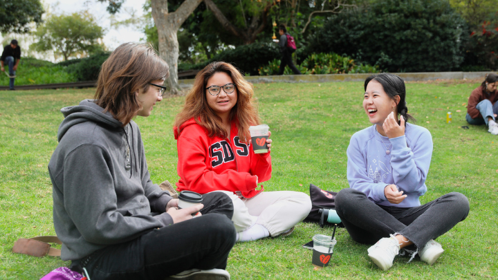 3 girls drinking coffee on a lawn